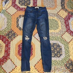 High rise blue skinny jeans with intentional rips
